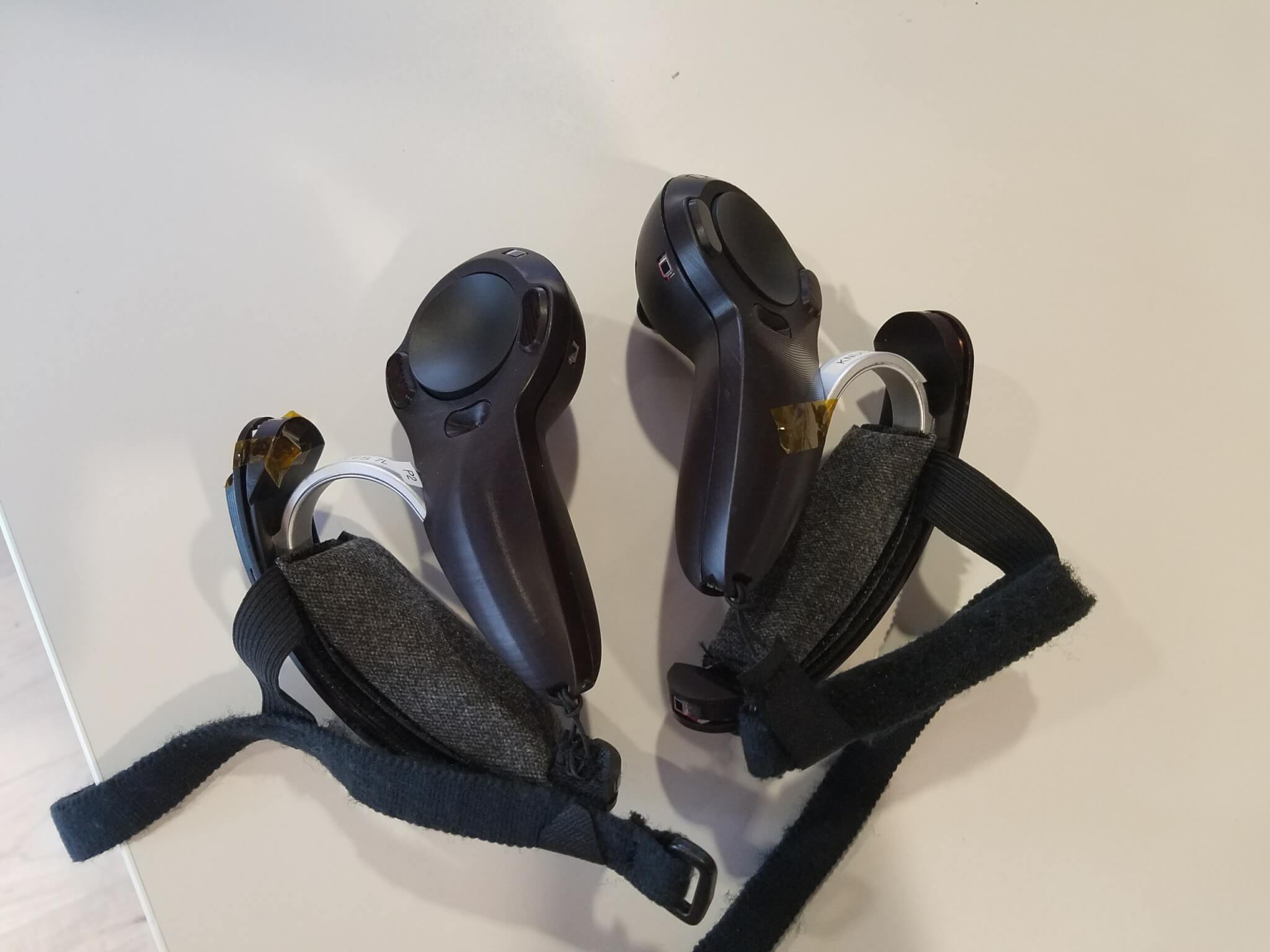 Valve's old Vive controllers with its prototype grip controllers. 