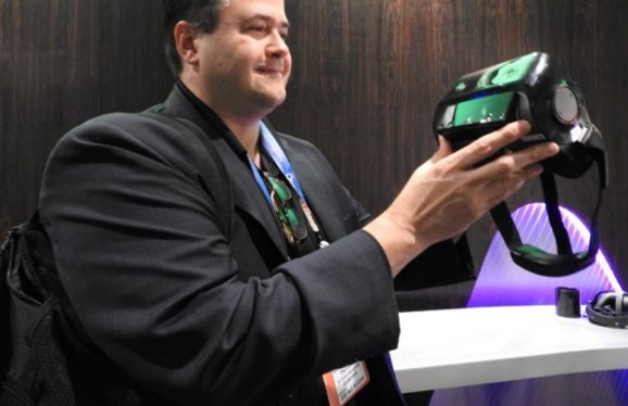 Tim Leland of Qualcomm's shows off wireless VR headset.